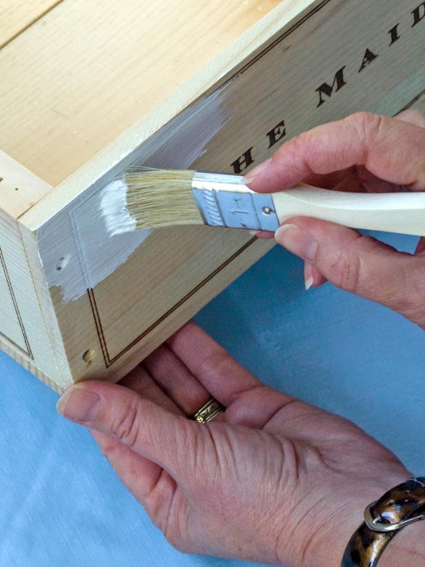Paint both crates white (or any color of your choosing) with acrylic paint and the large paintbrush (Image 1).