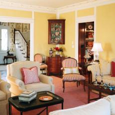 Yellow French Country Living Room With Red Accents