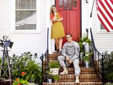 Soldier and wife in front of their renovated home. 