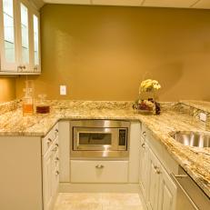 Small Transitional Kitchen With Neutral Marble Countertops