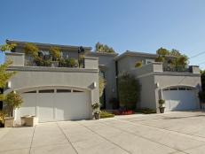 Gray Stucco Home Exterior WIth White Garage Doors