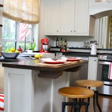 White Country-Style Kitchen with Red Appliances and Accents