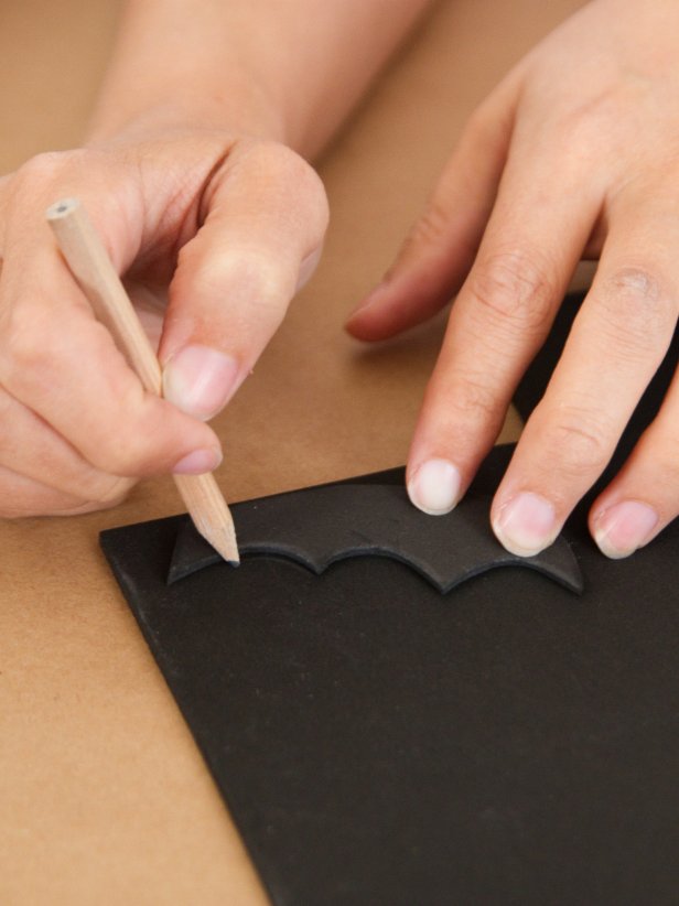 Using the first wing as a template, cut out as many wings as you'll need to attach two to each pumpkin.