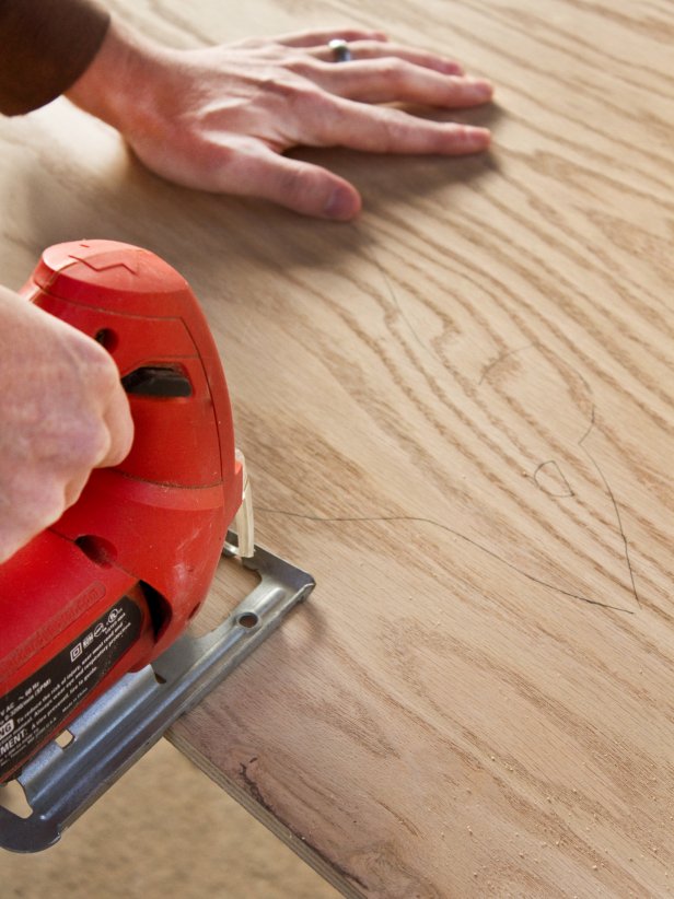 Man cutting rat out of plywood