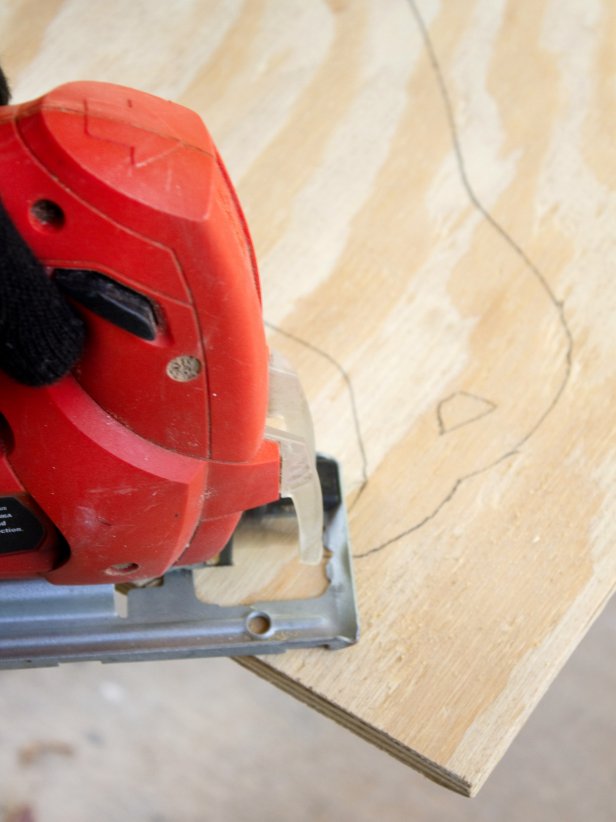 Jigsaw cutting traced raven out of plywood