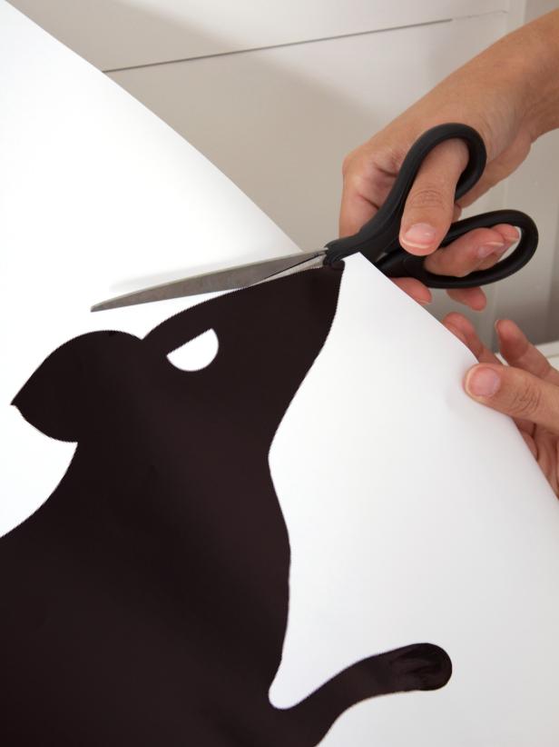 Man cutting out rat template