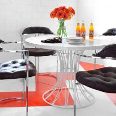Modern Black and White Dining Space With Orange Accents