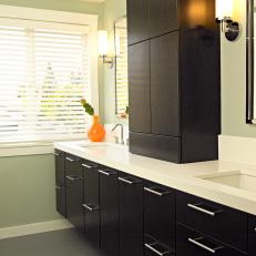 Green Modern Bathroom With White Counter and Black Cabinets