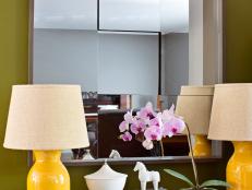 Modern Green Entryway With Side Table, Mirror and Yellow Lamps