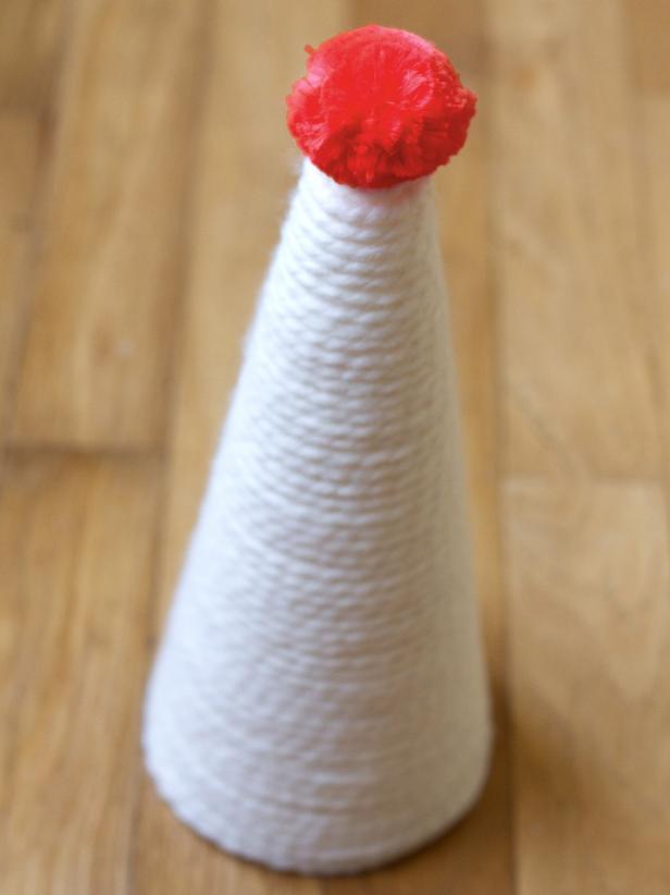 Attach a large pom-pom to the cone's top with hot glue.