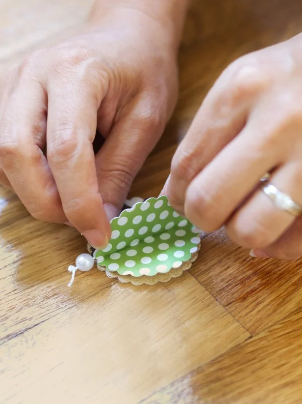 Stick the last two half-circles together to secure the twine, then glue all seven circles together, wrong side to wrong side, and hang completed ornament on a tree using the loop at the top.