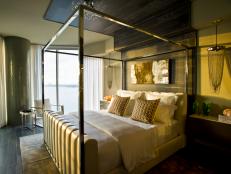 A sexy chrome-and-leather bed serves as the focal point in a sleek, water-view space.