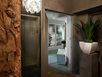 Entry Hall With Elevator, Driftwood Accents and Large Tropical Plant