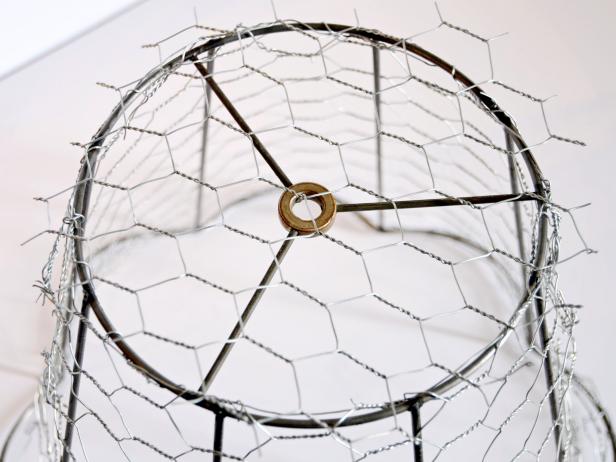 Cut a piece of chicken wire to fit on top of lampshade frame.