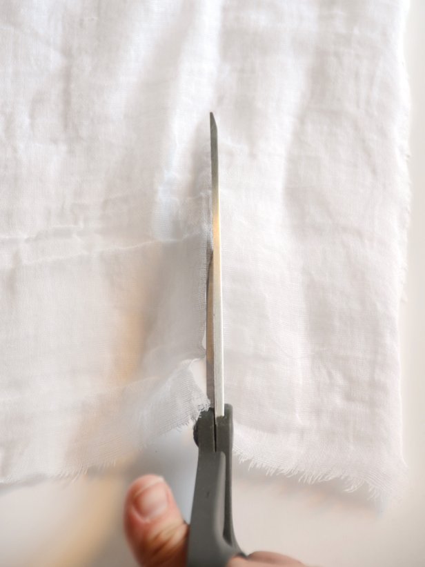 Person cutting cheesecloth 