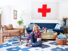 Emily Henderson in White Living Room With Vintage Red and White Flag