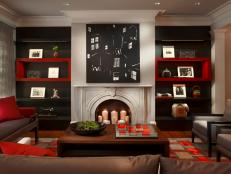Red and Black Living Room With Neutral Fireplace and Brown Coffee Table