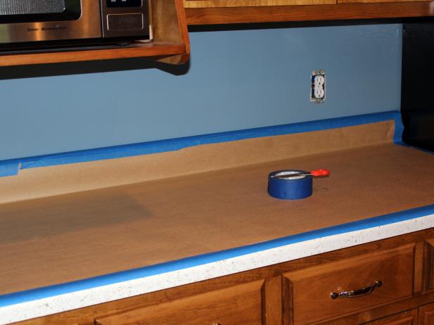 Protect countertops by covering them with a heavy-duty paper or plastic drop cloth and painter's tape. Remove switch plates and attach screws to plate backs with a piece of painter's tape so they won't become lost.