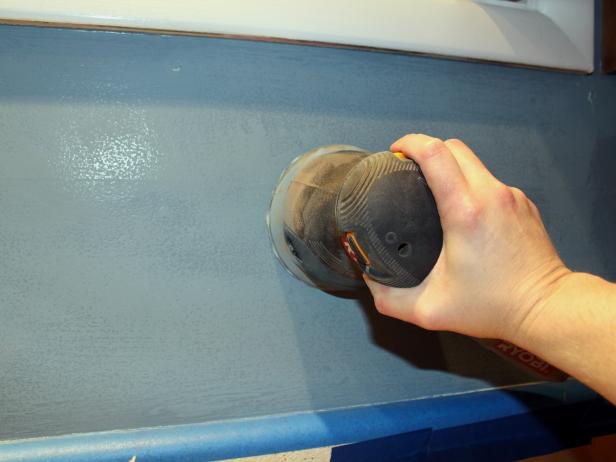 Using an orbital sander, go over all the areas where tile will be applied to smooth out any high spots and create a more tactile surface for applying mortar.