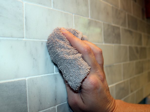 Check manufacturer's instructions and, after the recommended cure time, seal tile and grout using a soft cotton cloth and the same stone sealer you used before grouting.