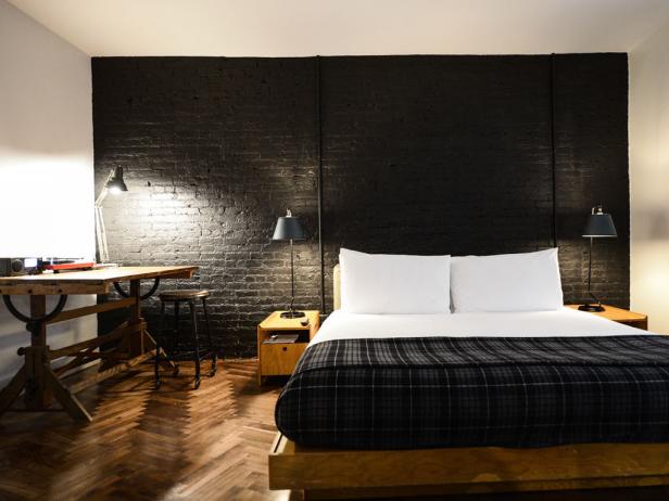 Ace Hotel Bedroom with a Black Brick Wall