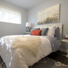 Serene Bedroom With Pale Blue Walls & Coastal Painting