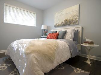 Pale Blue Bedroom With White Headboard, Painting, Sheepskin Throw