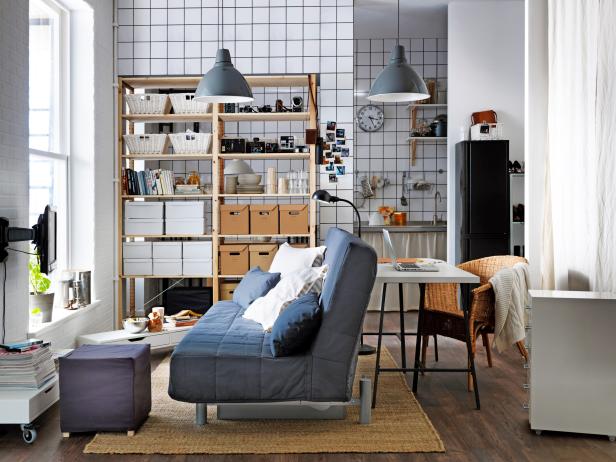 Living Space With Blue Futon and Black & White Grid-Patterned Walls