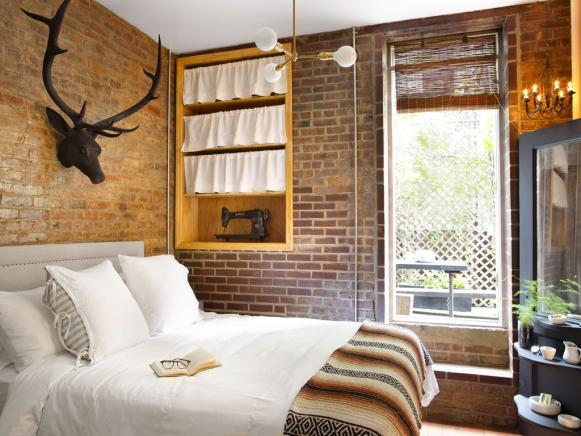 Exposed Brick Bedroom Decorated with Antiques 