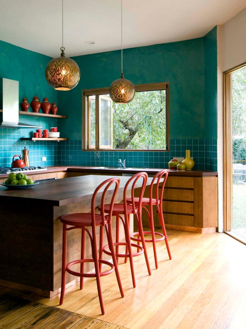 Eat-In Kitchen With Blue Tile Backsplash, Gold Light and Red Barstools
