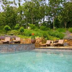 Outdoor Pool With Stacked Stone Retaining Wall