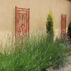 Pretty Outdoor Space With Red Trellises and Lavender Flowers