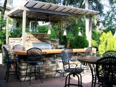 Outdoor Kitchen With a Bar Top and Eating Area