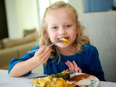 Little Girl Eating Thanksgiving Dinner
