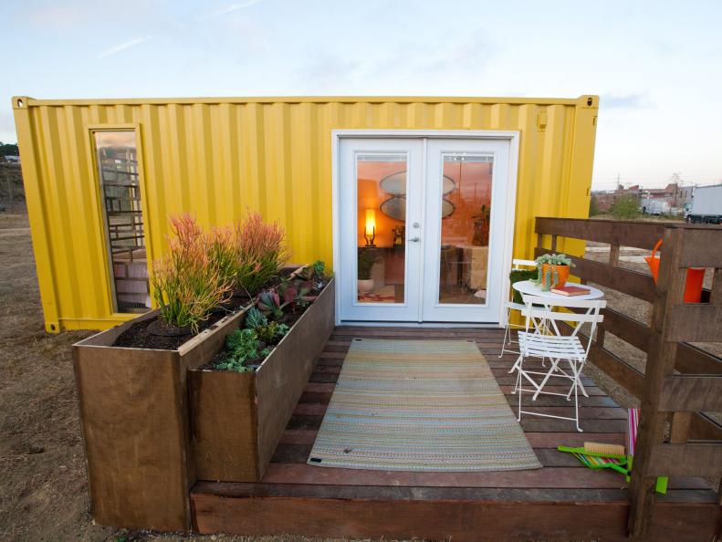 Yellow Shipping Container House With Deck and Small Garden