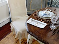 Dining Room With White Slipcovered Chair and Rustic Wood Dining Table