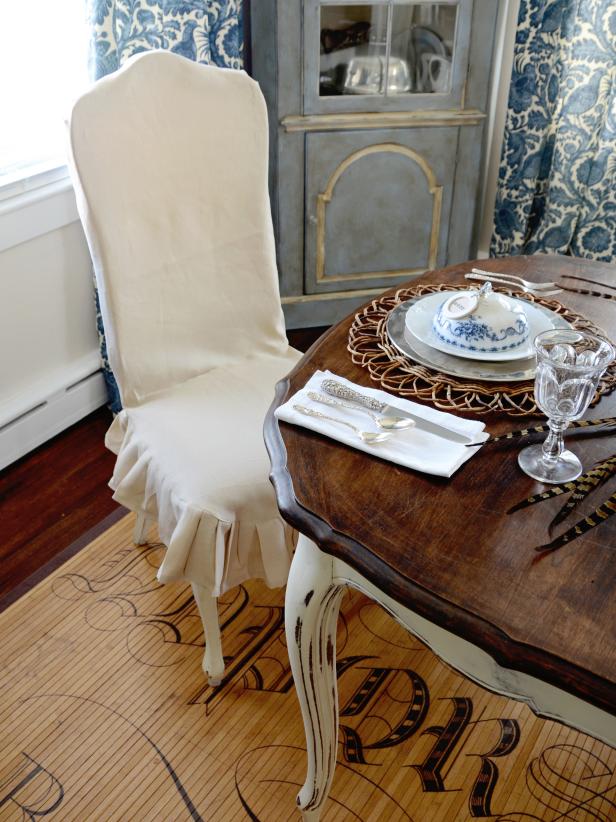 Dining Room With White Slipcovered Chair and Rustic Wood Dining Table