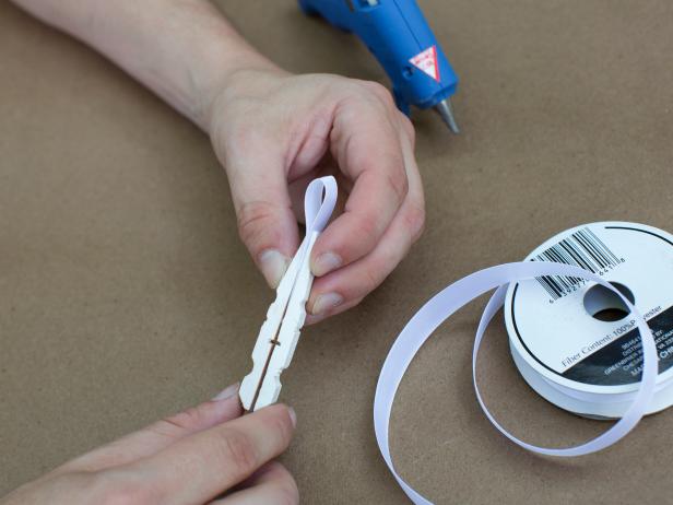 Before joining them together, insert ribbon loop to create a hanger and press both pieces together for approximately 90 seconds until the glue has cooled.