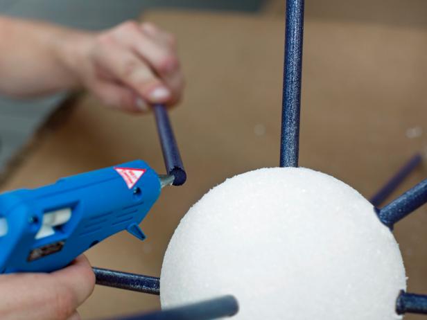 Remove each 3/8&quot; dowel from foam sphere, then add a dollop of hot glue to its tip. Re-insert each 3/8&quot; dowel into its previous position, ensuring a tight, secure fit. Once in place, add hot glue around the space between the foam sphere and the replaced dowel. Note: This extra layer of glue will add more stability to each dowel.