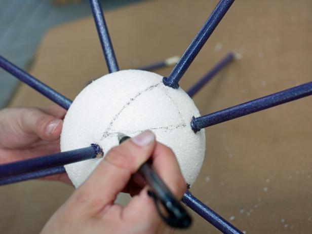 Using marker or pen, sketch a triangle directly onto the foam sphere between three of the inserted 3/8&quot; dowels.