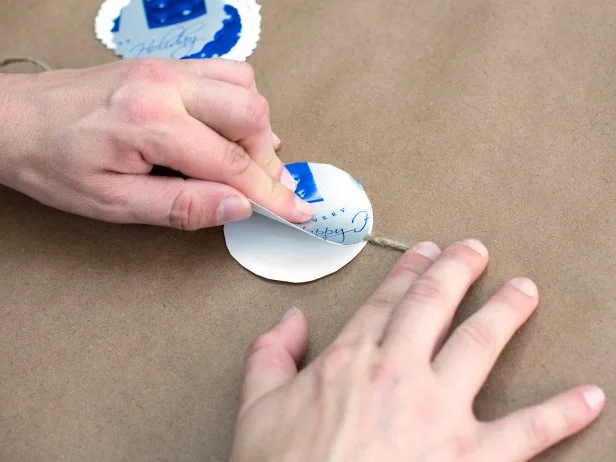 Press tightly until both circles have firmly adhered to the twine. Continue attaching cut-outs to the twine until you're satisfied with the length of the garland.