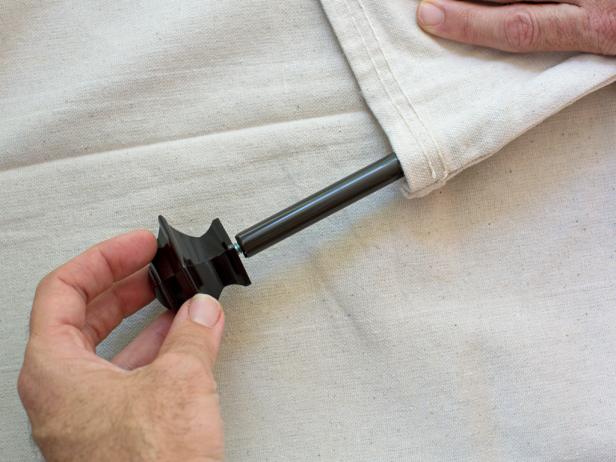 Insert thin-profile drapery rod into the rod pocket and attach finials to each end.