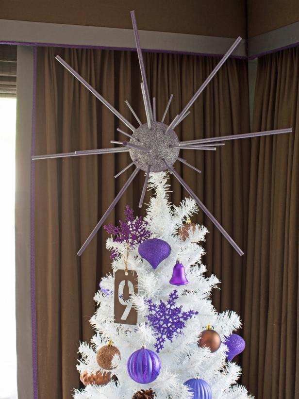 Handmade starburst tree topper on a white Christmas tree. 