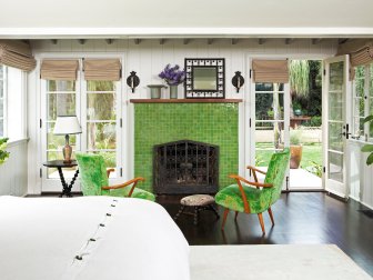 White Bedroom Sitting Area with Green Fireplace and Green Chairs
