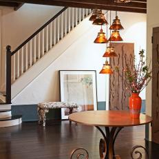 Eclectic Foyer With Tiered Copper Pendants