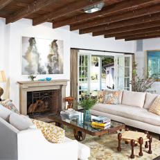 White Living Room with Exposed-Beam Ceiling