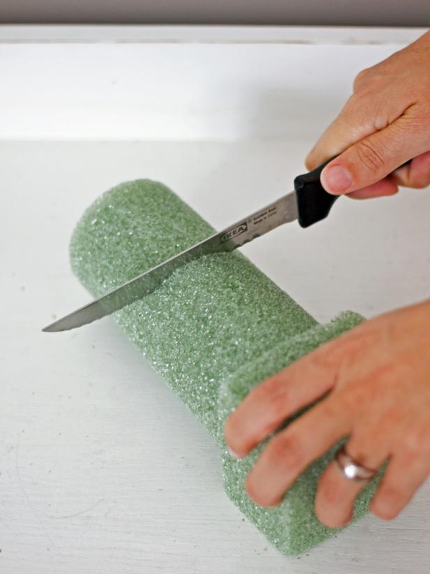 Use a sharp knife to cut the top off the foam monument insert so it's shorter than the glass cylinder.