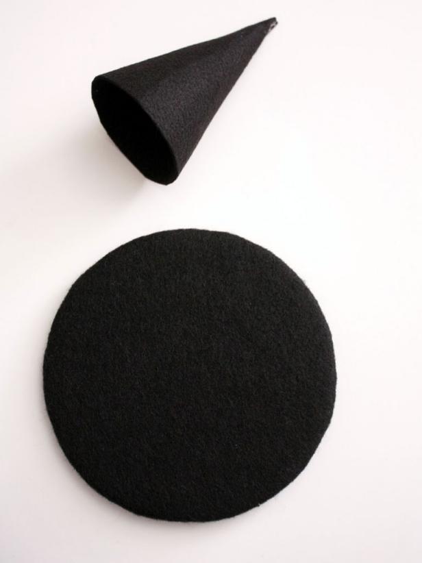 Wrap a circle of black felt around cardboard and glue in place. Roll stiff felt into a cone shape. Cut off excess and glue on top of the circle.