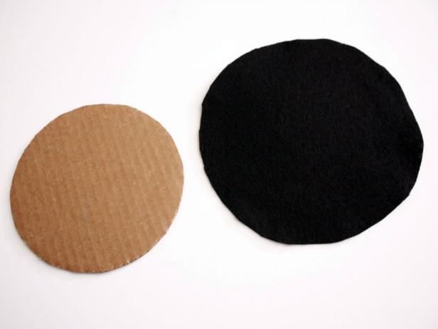 Cut out a circle of black felt and circle of cardboard in a slightly smaller size.
