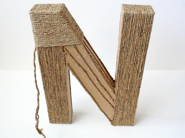 Start winding jute around the letter in one direction, then fill in the opposite way for complete coverage.